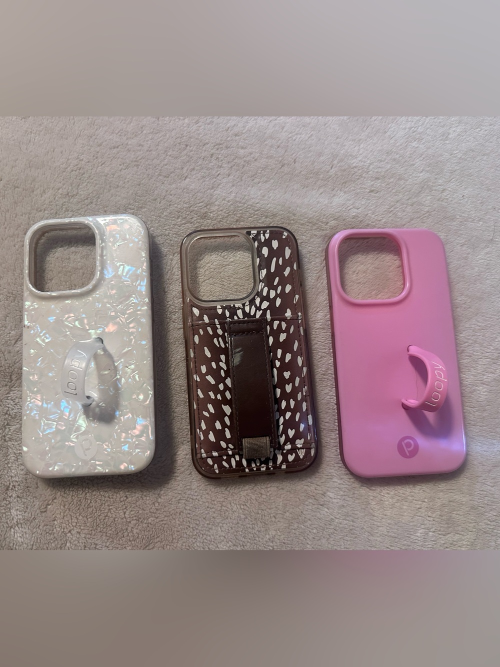 Loopy Case in pink and white crystal & a Walli case all fit an iPhone 14pro